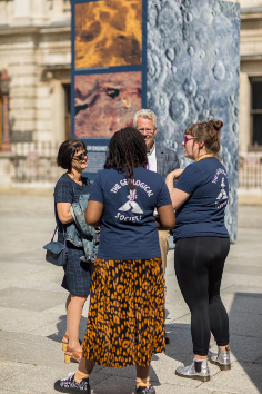 staff from the geological society talking with members of the public at the exhibition